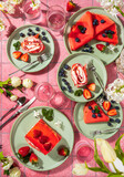 Delicious reddish pancakes and strawberry cake served on green plates for a fancy brunch