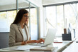 © Stock 4 You - Focused middle aged business woman using laptop at work in office. Professional female executive entrepreneur in suit working on computer pc at company workplace, doing financial analyze. Copy space