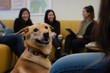 © Татьяна Евдокимова - Happy dog sitting in an office with coworkers laughing in the background, enjoying a friendly and pet inclusive workplace