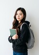 © Raditya Pawitra  - beautiful young woman asian a student holding books with a bag standing up right white background