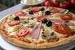 © ccLemon - Pizza with tomato, ham, mushrooms, artichokes, and olives
