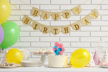 Wall Mural - table with cake, sweets and decor for birthday party against white brick wall