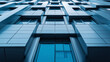 © Frank Gärtner - Low angle view of a modern building facade reflecting the blue sky, creating an abstract and geometric pattern with its rectangular shapes