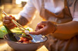 © Marko Geber - Male asian chef preparing a traditional food dish in a restaurant kitchen