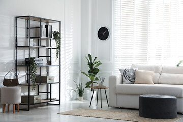 Poster - Stylish shelving unit with decor and sofa in room