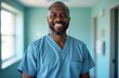 © miss irine - Smiling black man in medical scrubs. Doctor, nurse or medical staff member in hospital corridor. Happy healthcare professional. Smiling, friendly face.
