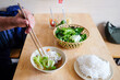 © Studio KME/Stocksy - Adding Fresh Herbs to Noodle Soup