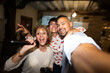 © Alvaro Lavin/Stocksy - Friends taking selfie while singing karaoke and having fun
