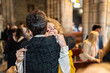 © Alvaro Lavin/Stocksy - Two women hugging inside a church after a ceremony