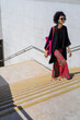 © tessy morelli/Stocksy - Minimal architecture staircase woman walking portrait