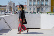 © tessy morelli/Stocksy - Lisbon Praca do Comercio Square woman walking
