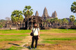 © Studio KME/Stocksy - Tourist in Front of Angkor Wat