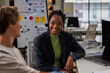 © Jovo Jovanovic/Stocksy - Smiling businesswoman discussing with colleague in office