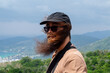 © Studio KME/Stocksy - Bearded Man with Windblown Hair Overlooking a View