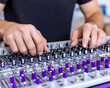 © CHURIN - Close-up of hands adjusting audio mixer controls AI generative