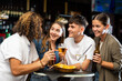 © JackF - Two couples spending time in bar, having fun while drinking beer and talking.