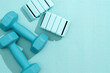 © Basil Pind/Stocksy - Blue Dumbbells and Wrist Weights on Yoga Mat
