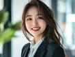 © Surachetsh - Portrait of a smiling Japanese businesswoman, her expression reflecting accomplishment and success in the workplace.