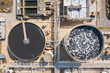 © Lawren Lu/Stocksy - Aerial view of wastewater treatment plant with circular tanks