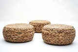 Three woven water hyacinth ottomans against a white backdrop, perfect for home decor
