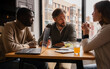© VICTOR TORRES/Stocksy - Team members in a collaborative meeting by the window