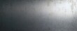 © miss irine - Brushed metal surface with light gradient. Industrial steel texture with scratches, perfect for banner with copy space. Grey, silver, aluminium, stainless steel background. Ideal for industrial tech