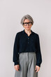© Viktor Solomin/Stocksy - Senior woman with gray hair and glasses