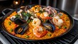 © vachiraphan - Delicious Seafood Paella with Shrimp and Mussels in a Vibrant Pan