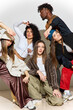 © Javier Díez/Stocksy - Creative group pose of stylish individuals in urban fashion sett