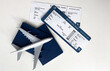 © Angelov - Passport, boarding pass and toy airplane on table top view