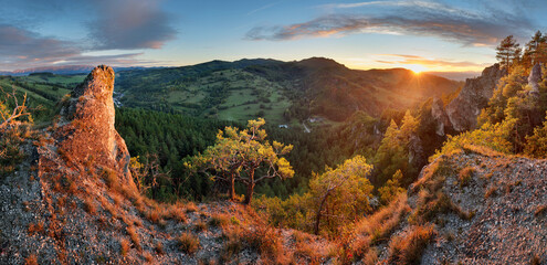 Poster - Panoramic view of mountain range under colorful blue and orange sundown in Slovakia. Rocky forest landscape