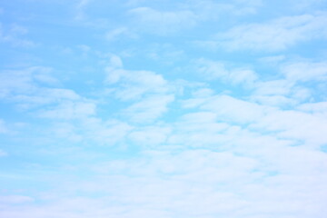 Wall Mural - White clouds in a blue bright sky.