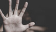 © Tinnakorn - hand on black background