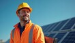 © Maryna - Smiling worker in yellow helmet and orange reflective vest on rooftop near solar panels. Professional male engineer, happy with renewable eco-friendly green energy. Modern tech, sustainable future.