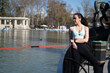 © VictorCanalesStudio - Young sportswoman resting after exercising by the lake of retiro park in madrid, spain