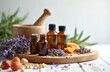 © Maryna - Herbal medicine concept. Essential oil bottles, mortar, pestle, lavender, orange slices, dried herbs on wooden board. Natural remedy, alternative medicine, aromatherapy, homeopathic treatment,