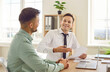 © Studio Romantic - Two cheerful business people having fun during a work meeting. Two happy men sitting at an office desk together, working with documents, using a modern laptop computer and laughing