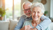© Radorog. - Happy elderly couple hugging in the living room sitting on the couch