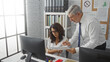 © Krakenimages.com - Man and woman discussing papers in a modern office environment showcasing teamwork and professional interaction among colleagues in a work setting with computers and documents.