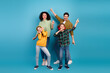 © deagreez - Happy family dancing together in colorful casual outfits on vibrant blue background celebrating joy and togetherness