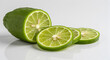 © Aulia - Refreshing sliced finger lime segments on a white surface showcasing citrus texture