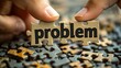© qazi - Hand holding the word 'problem' on a jigsaw puzzle to assemble a solution for creative thinking, symbolizing critical thinking and problem-solving in business.