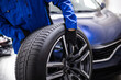 © zphoto83 - Worker changes tire on vehicle in automotive shop during daylight hours