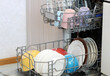 © MaskaRad - Open dishwasher showing clean dishes and mugs ready to be unloaded