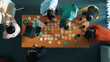 © InfiniteFlow - Top view of skilled business people discuss plan at meeting room while writing idea at sticky notes and stick at whiteboard. Group of diverse team working together to planning strategy. Convocation.