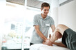 © peopleimages.com - Client, man or physiotherapist with leg rehabilitation in office for knee injury for orthopedic support. Calf treatment, mobility help or professional pt with physiotherapy service or muscle recovery