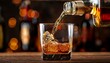 © Vance - detail of pouring whiskey into glass freeze motion drink preparation