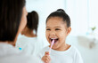 © Kay Abrahams/peopleimages.com - House, mother and girl with help, brushing teeth and morning routine with dental hygiene. Family, bathroom and single parent with daughter, kid and childhood with oral health, fresh breath and smile