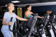 © JackF - Focused aged woman leading healthy active lifestyle doing cardio workout on elliptical machine in modern gym