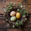 © Andrii - Colorful eggs in a handmade nest on wooden surface